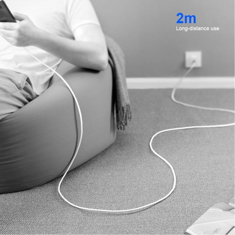 White USB-C charging cable with 2m length, lying on carpet with connector visible