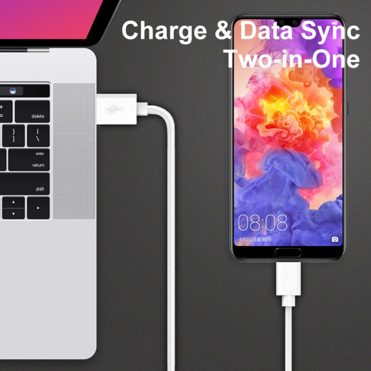 USB-A to Micro-USB cable connected between laptop and phone for charging and sync.