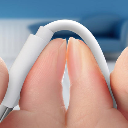 White Micro USB charging cable held by fingers, connector end close-up