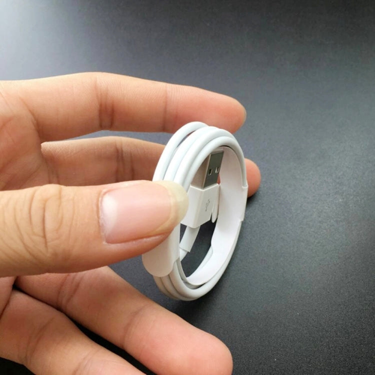 Hand holding a white USB-A connector end on a Micro USB charging cable