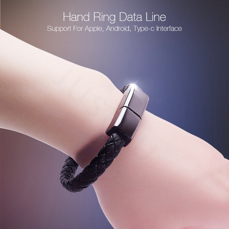 Black hand ring data cable bracelet with metal clasp worn on wrist