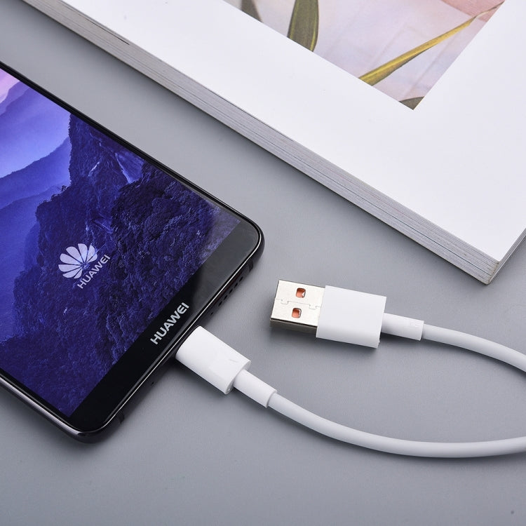 USB-A to USB-C cable charging a smartphone on a desk surface