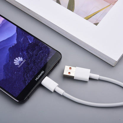 USB-A to USB-C cable charging a smartphone on a desk surface
