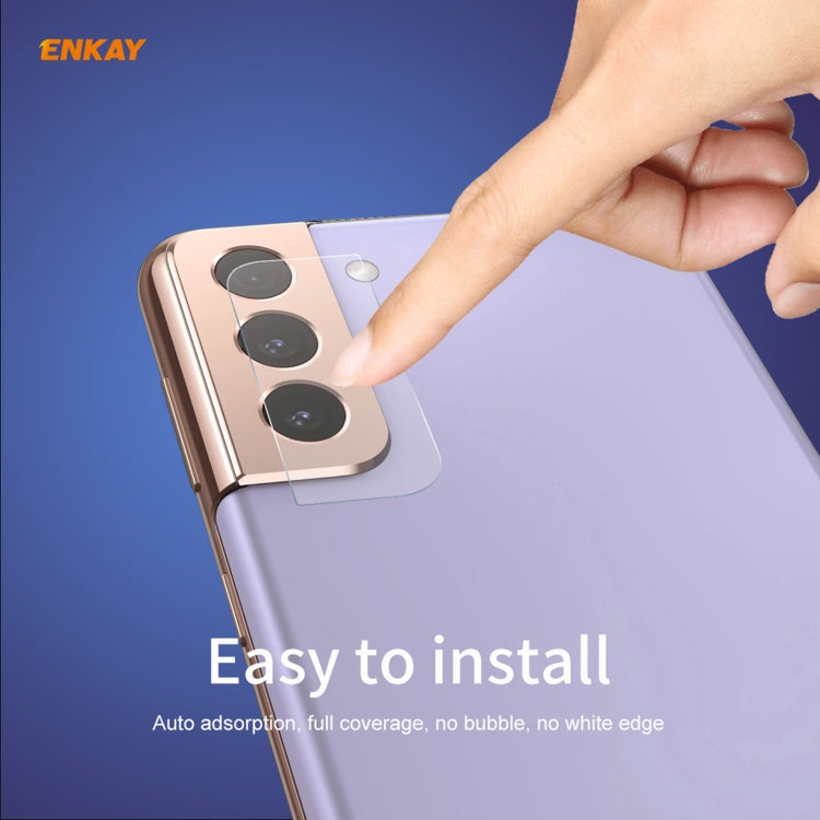Hand applying clear tempered glass rear camera lens protector film