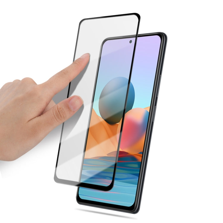 Smartphone screen protector film being applied by hand, clear tempered glass sheet