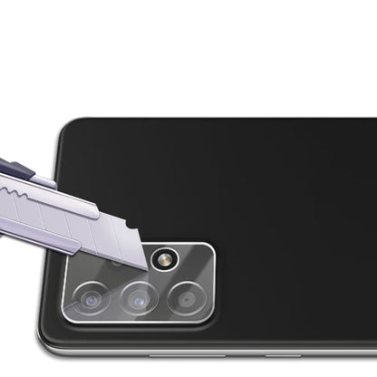 Tempered glass lens shield being applied over a phone’s rear camera lenses