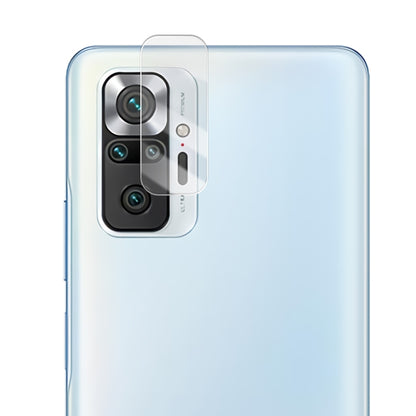 Transparent 2.5D tempered glass rear camera lens shield on light-colored phone back.