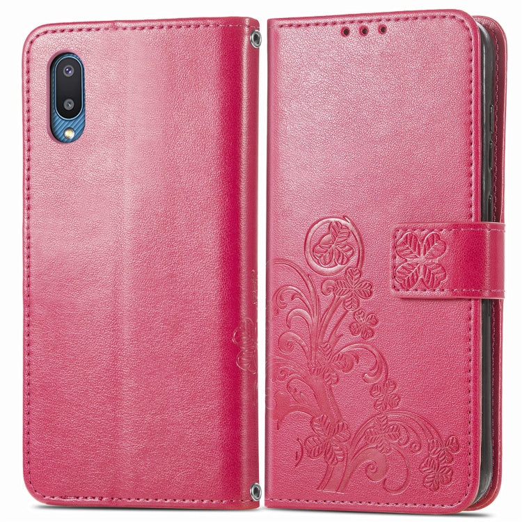 Rose red folio leather phone case with embossed floral pattern and side cover strap.