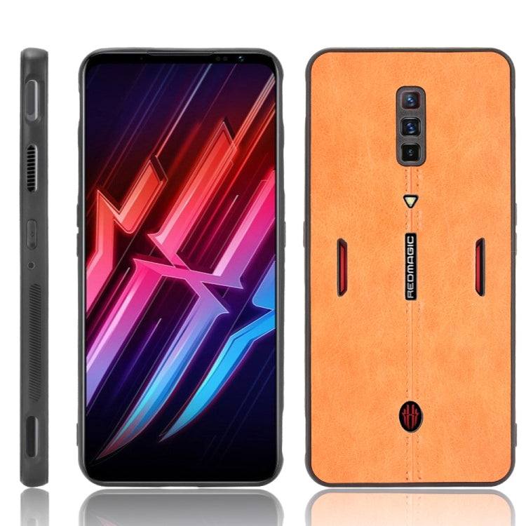 Shockproof phone case with orange textured back, cutouts for camera and side buttons