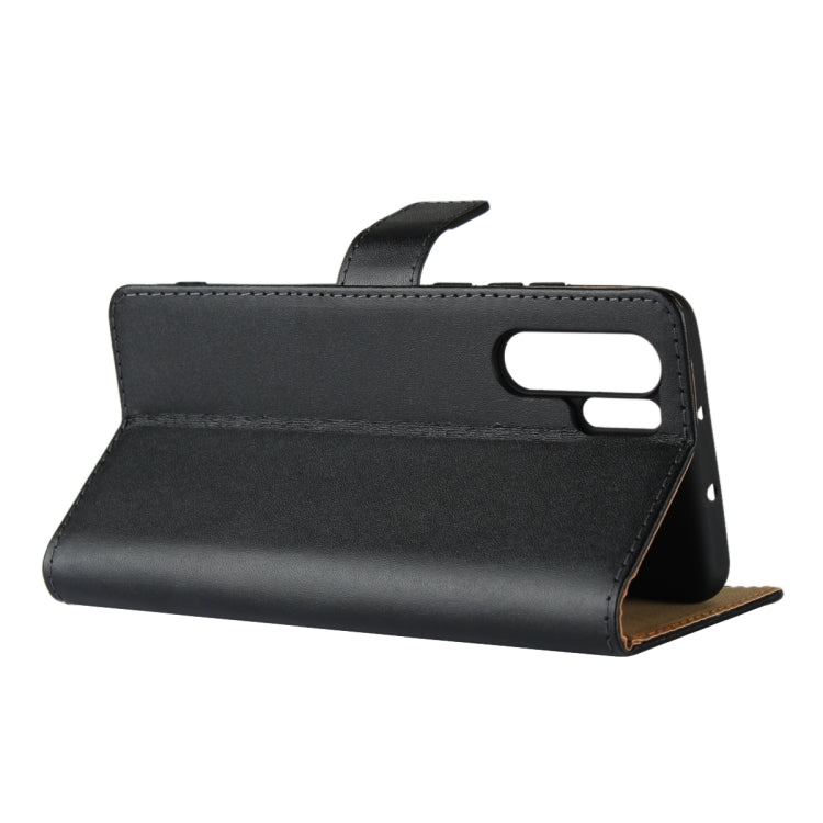 Black leather flip holster wallet case standing, showing top cutouts and stitching