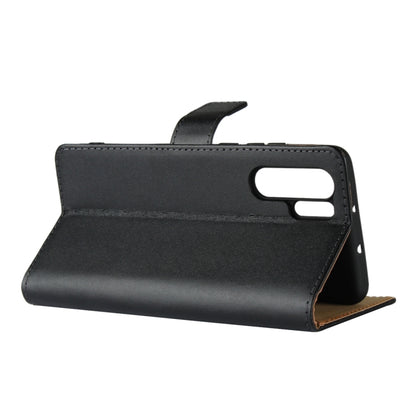 Black leather flip holster wallet case standing, showing top cutouts and stitching