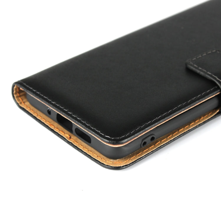 Black leather case bottom edge with port cutouts and tan side stitching