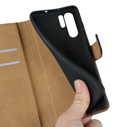 Black leather flip wallet case opened with phone inserted and hand lifting
