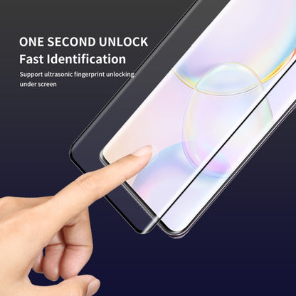 Curved tempered glass screen protector being applied to a smartphone screen by a hand.