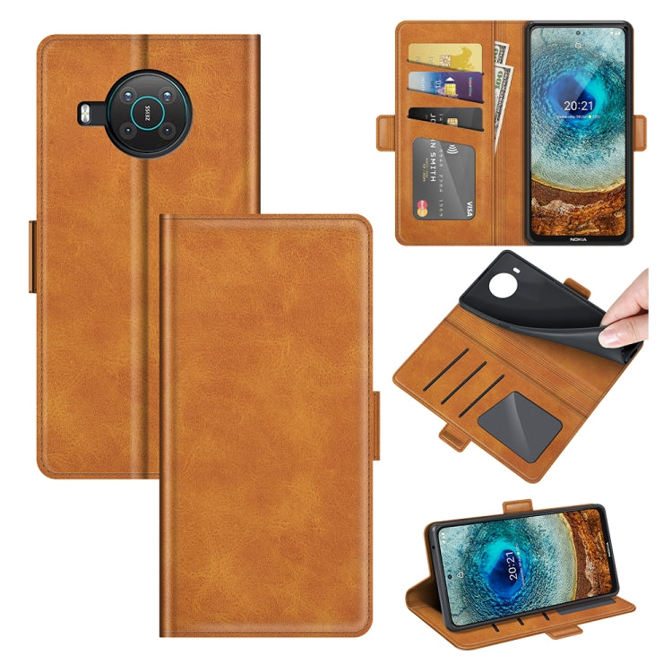 Brown flip leather phone case with magnetic buckle, card slots, and wallet holder