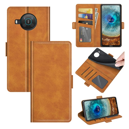 Brown flip leather phone case with magnetic buckle, card slots, and wallet holder
