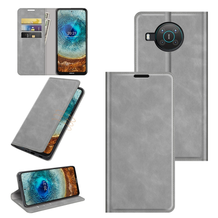 Grey leather phone wallet case with card slots, magnetic closure, and built-in stand