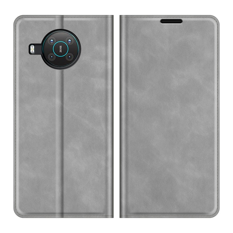 Grey leather phone case with magnetic flap and camera cutout; front and back view
