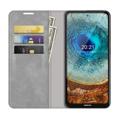 Grey leather phone wallet case with card slots and magnetic closure; phone shown open