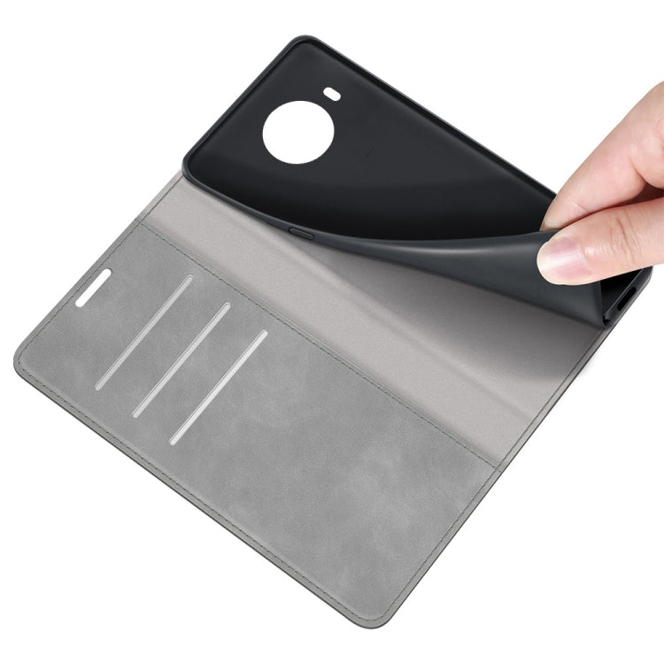 Grey leather phone wallet case with card slots; hand lifting cover for insertion
