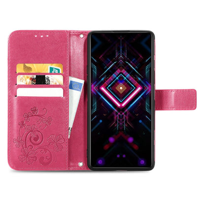 Pink folio phone case with embossed four-leaf pattern, card slots, open front, lanyard