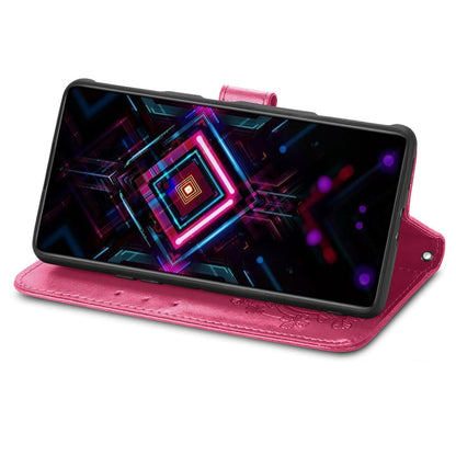 Pink folio wallet phone case with embossed design, kickstand for viewing, lanyard