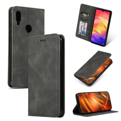 Dark gray leather flip phone case with magnetic closure and camera and speaker cutouts