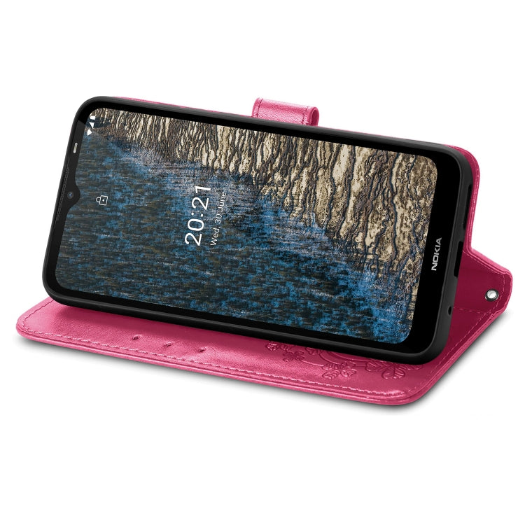 Magenta leather wallet phone case with embossed floral pattern, flip stand, lanyard strap