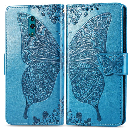 Blue embossed flip phone wallet case with butterfly and floral pattern, folded view