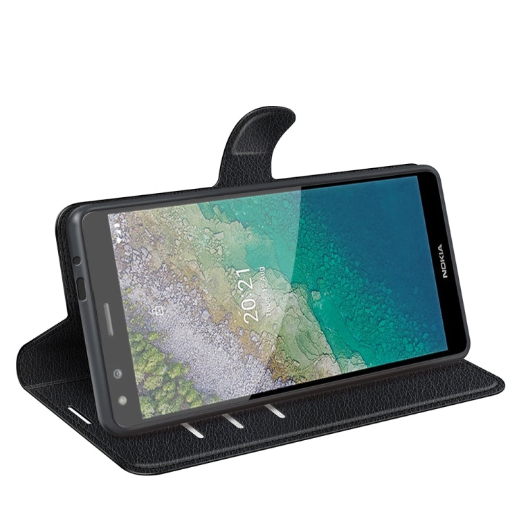 Black flip wallet phone case with stand position for landscape viewing.