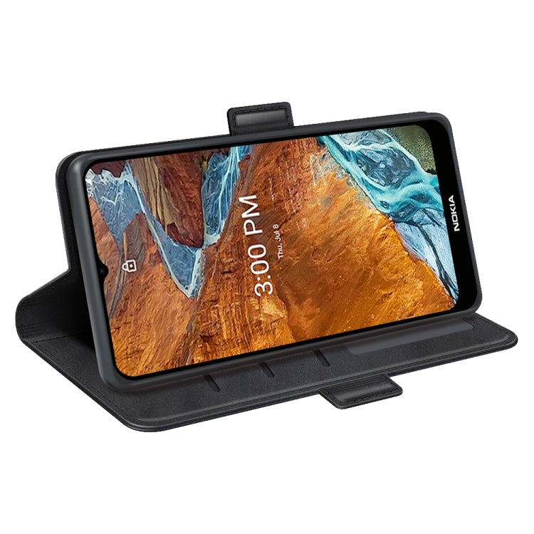 Black leather phone case with magnetic buckle in stand mode, front cover folded back