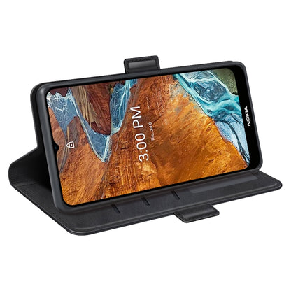 Black leather phone case with magnetic buckle in stand mode, front cover folded back