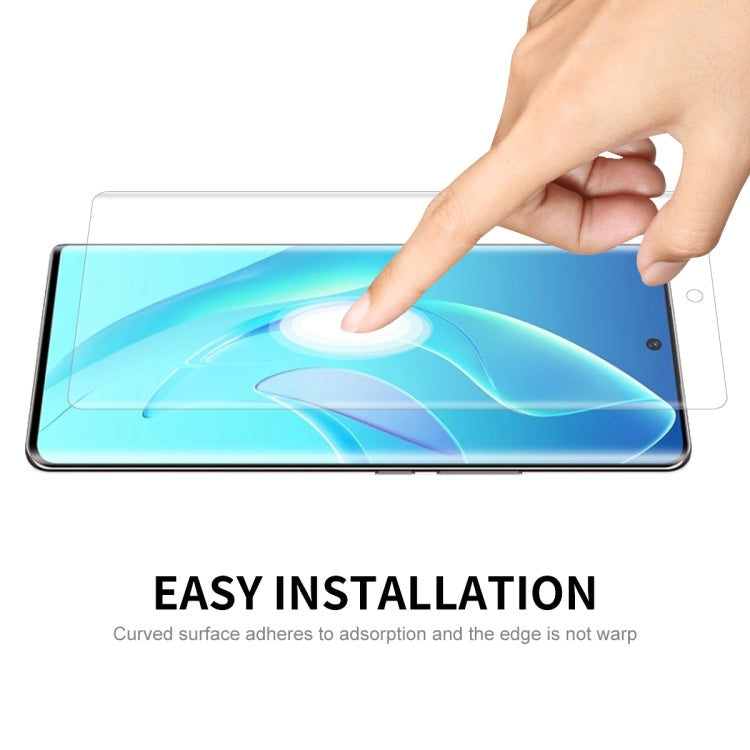 Finger installing a curved edge screen protector film on a smartphone screen