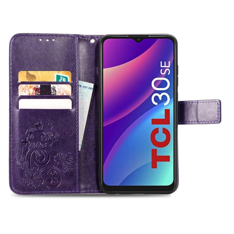 Purple embossed leather wallet phone case opened, showing card slots and four-leaf clasp