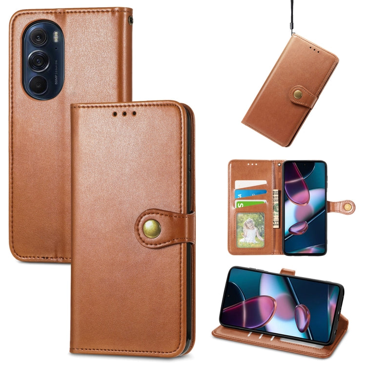 Brown leather flip phone case with gold buckle, card slots, and stand