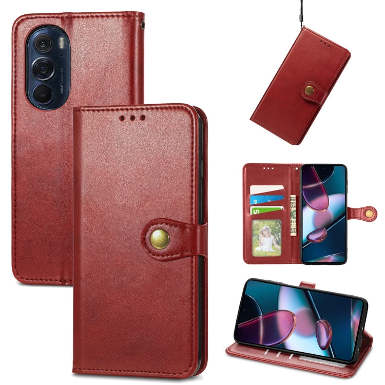 Red leather flip phone case with gold buckle, card slot, and viewing stand