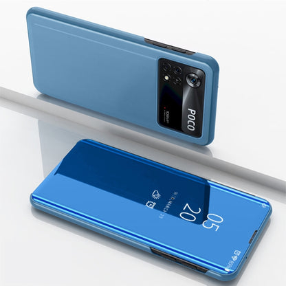 Blue horizontal flip mirror case with holder; phone back and open reflective front panel.