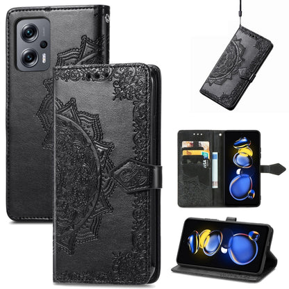 Black embossed mandala flip leather phone case with magnetic strap.