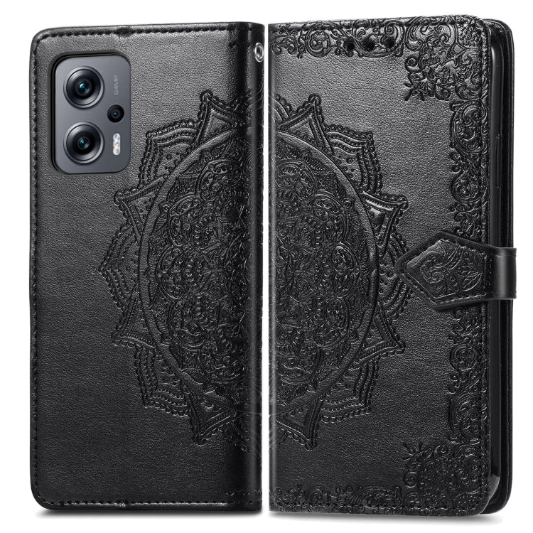Black embossed mandala flip leather phone case with cover closed and strap.