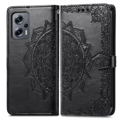 Black embossed mandala flip leather phone case with cover closed and strap.