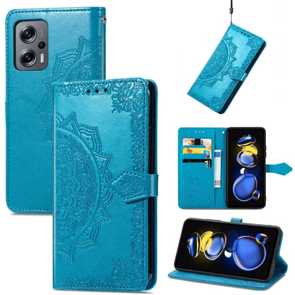 Blue embossed mandala flip leather phone case with magnetic strap.