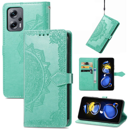 Mint green embossed mandala flip leather phone case with magnetic strap.