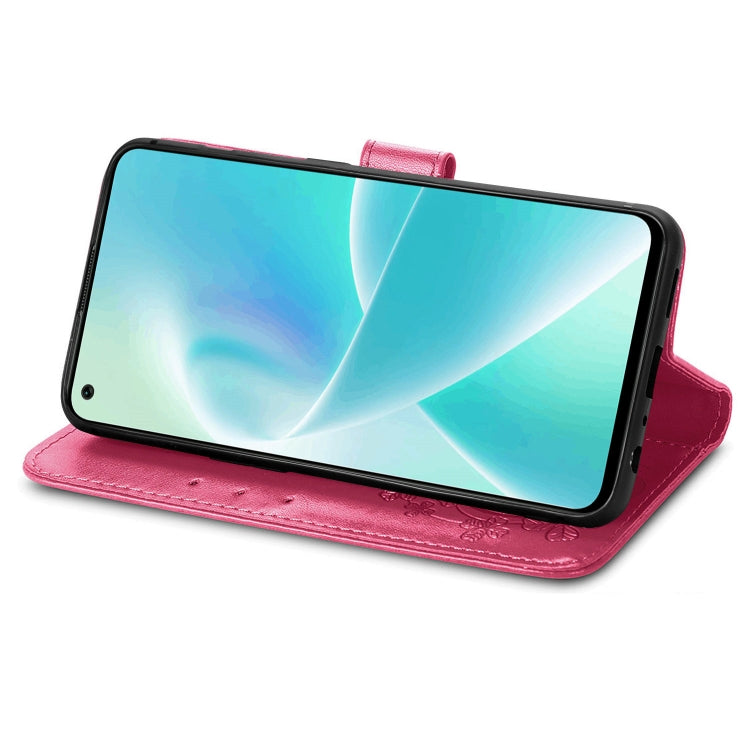 Rose red leather folio phone case with embossed floral detail, side stand, and buckle strap