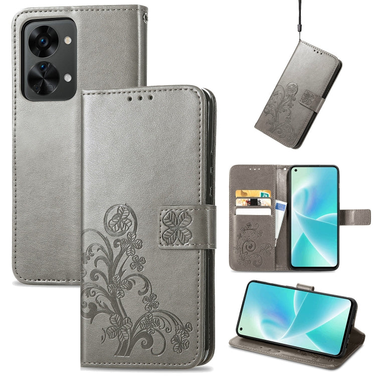 Gray leather wallet phone case with embossed floral pattern, buckle closure, and card slots