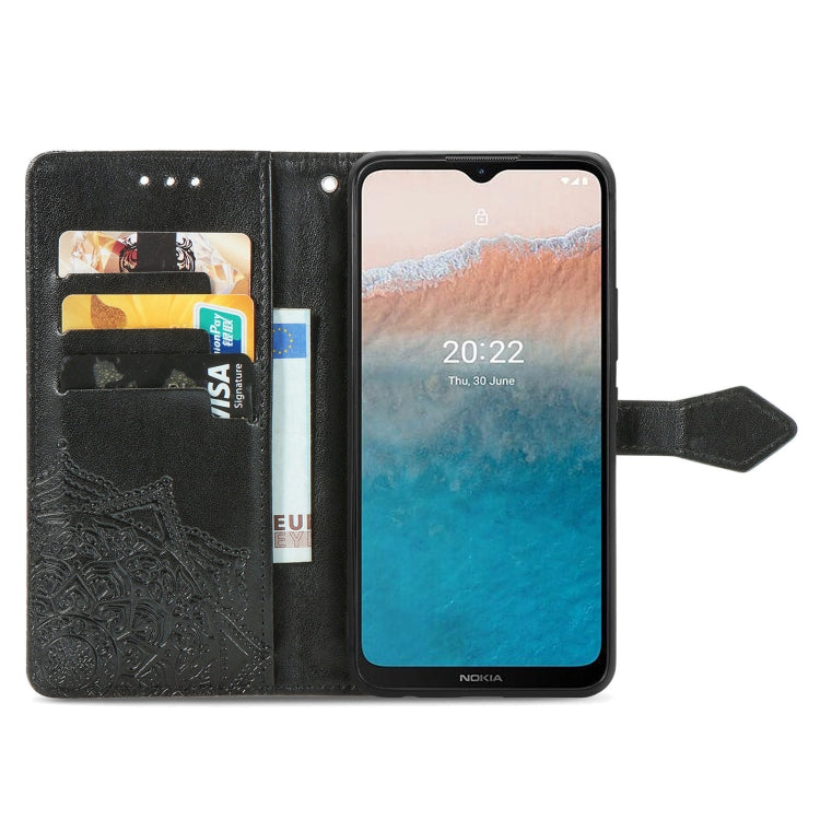Black embossed leather wallet-style flip phone case with mandala pattern and card slots