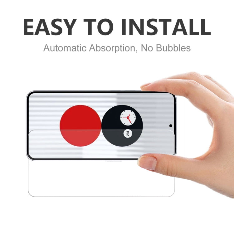 Tempered glass screen protector being applied to smartphone screen by hand