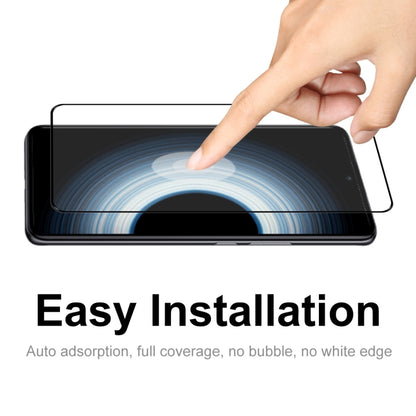Tempered glass screen protector being applied to phone screen by hand