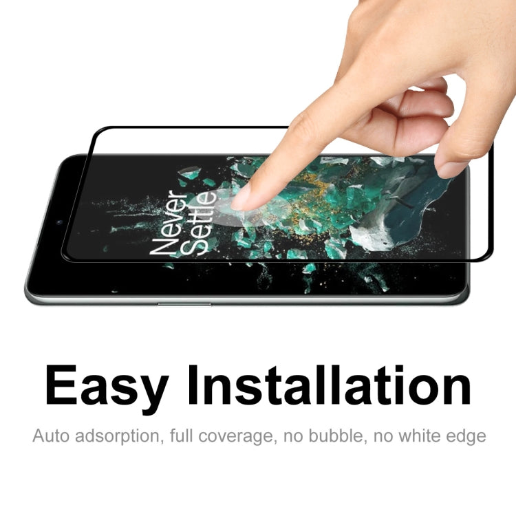 Tempered glass screen protector on smartphone screen being pressed into place by hand