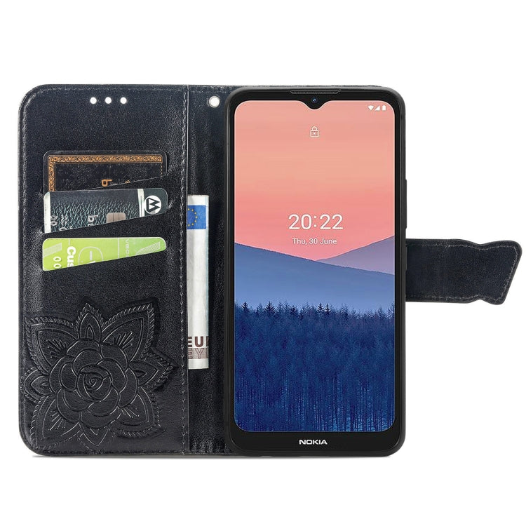 Dark blue flip phone case with embossed butterfly and flower rose design, card slots visible