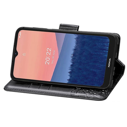Black flip phone case with embossed butterfly and floral pattern, phone in landscape stand